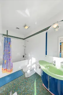 a bathroom with a sink mirror and a bath tub