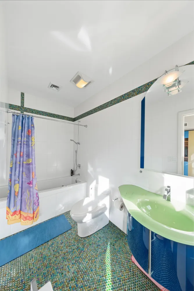 a bathroom with a sink mirror and a bath tub