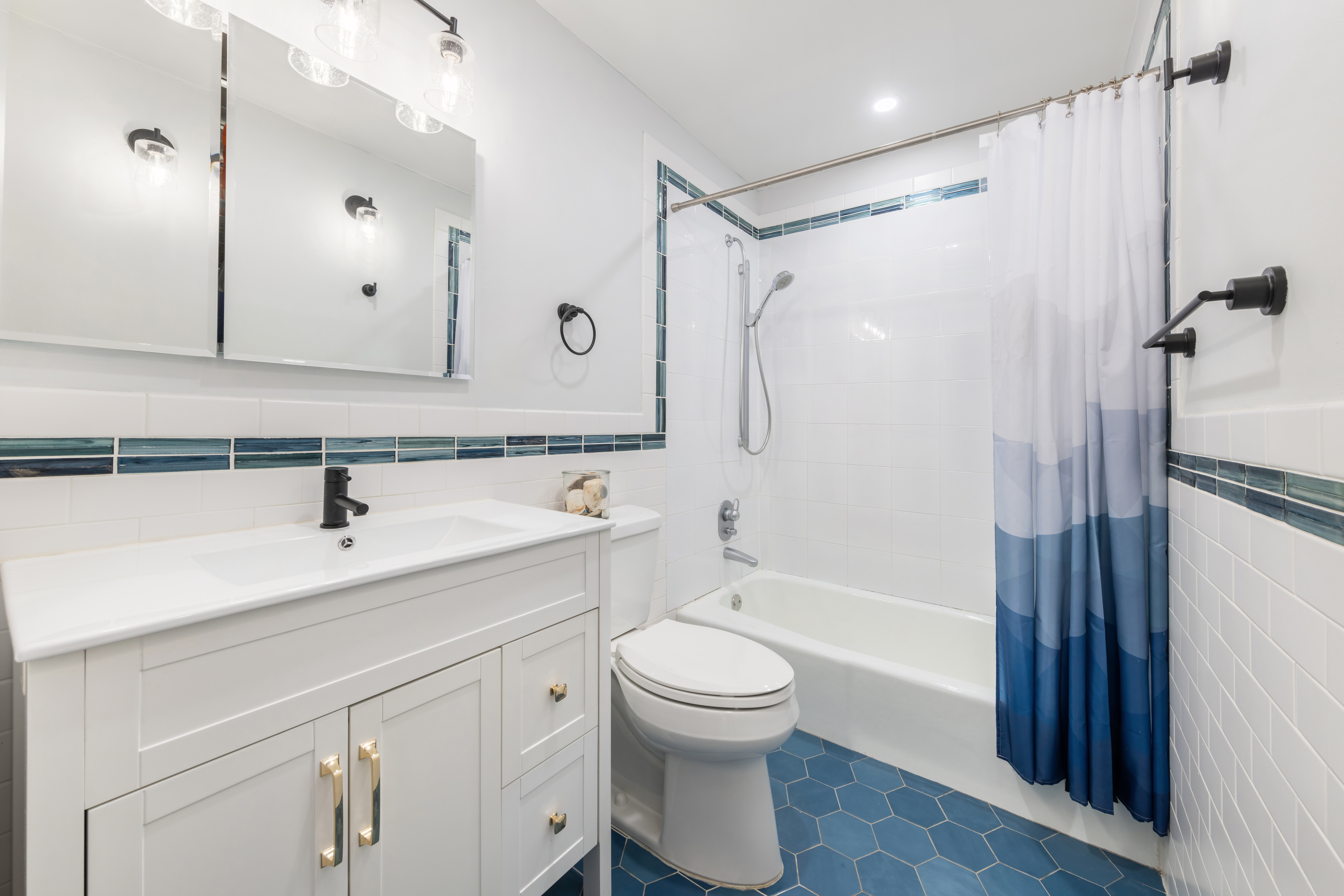99 Reade Street, Unit 5E Manhattan, NY 10013 - Photo 11 of 13 a bathroom with a sink a toilet and a large mirror