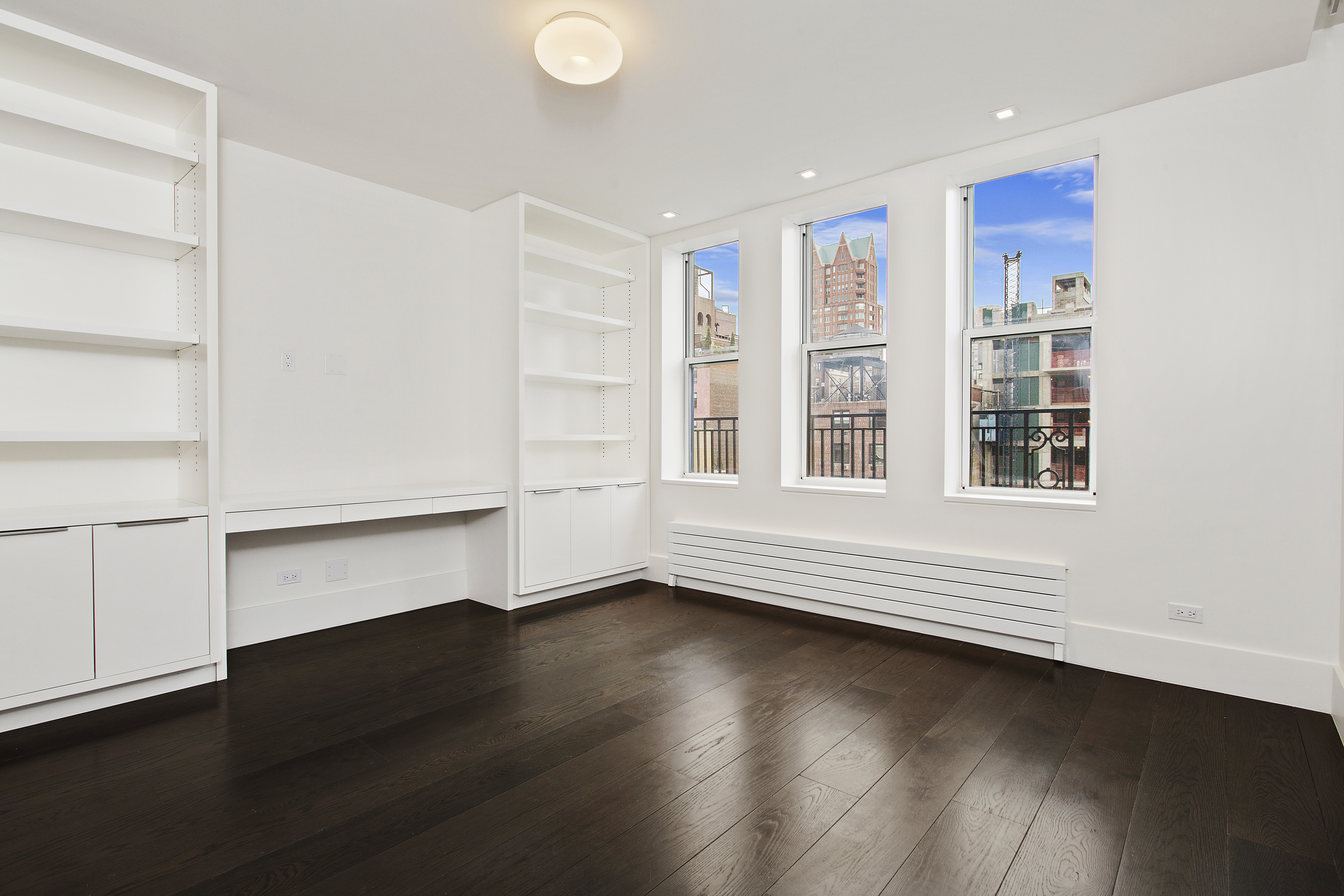 East 80th Street Manhattan, NY 10075 - Photo 9 of 13 a view of an empty room with a window and wooden floor