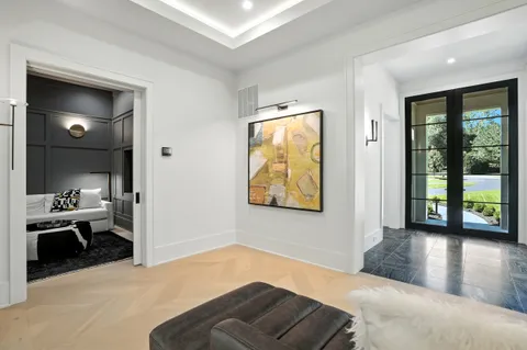 a living room with furniture a fireplace and a floor to ceiling window
