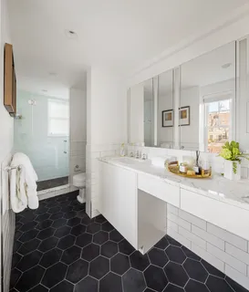 a bathroom with a double vanity sink mirror and toilet