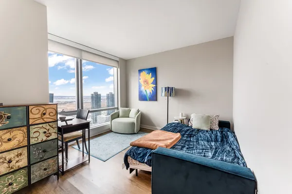 a living room with furniture and a floor to ceiling window