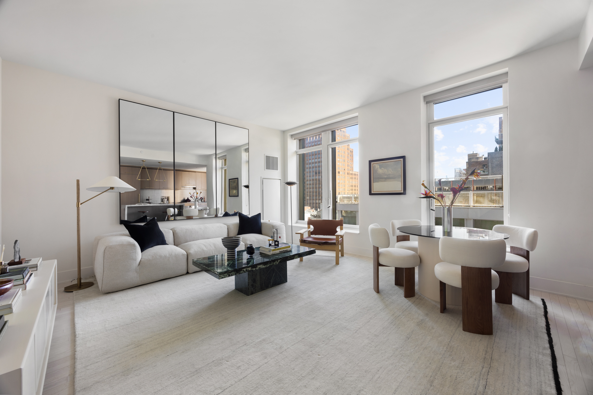 91 Leonard Street, Unit 11G Manhattan, NY 10013 - Photo 2 of 16 a living room with furniture and a large window