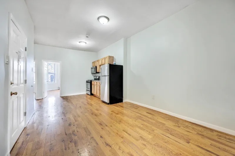 255 Covert Street Brooklyn, NY 11207 - Photo 3 of 18 a view of empty room with wooden floor