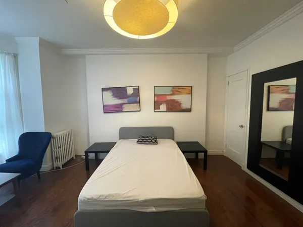 a bedroom with a bed and a lamp