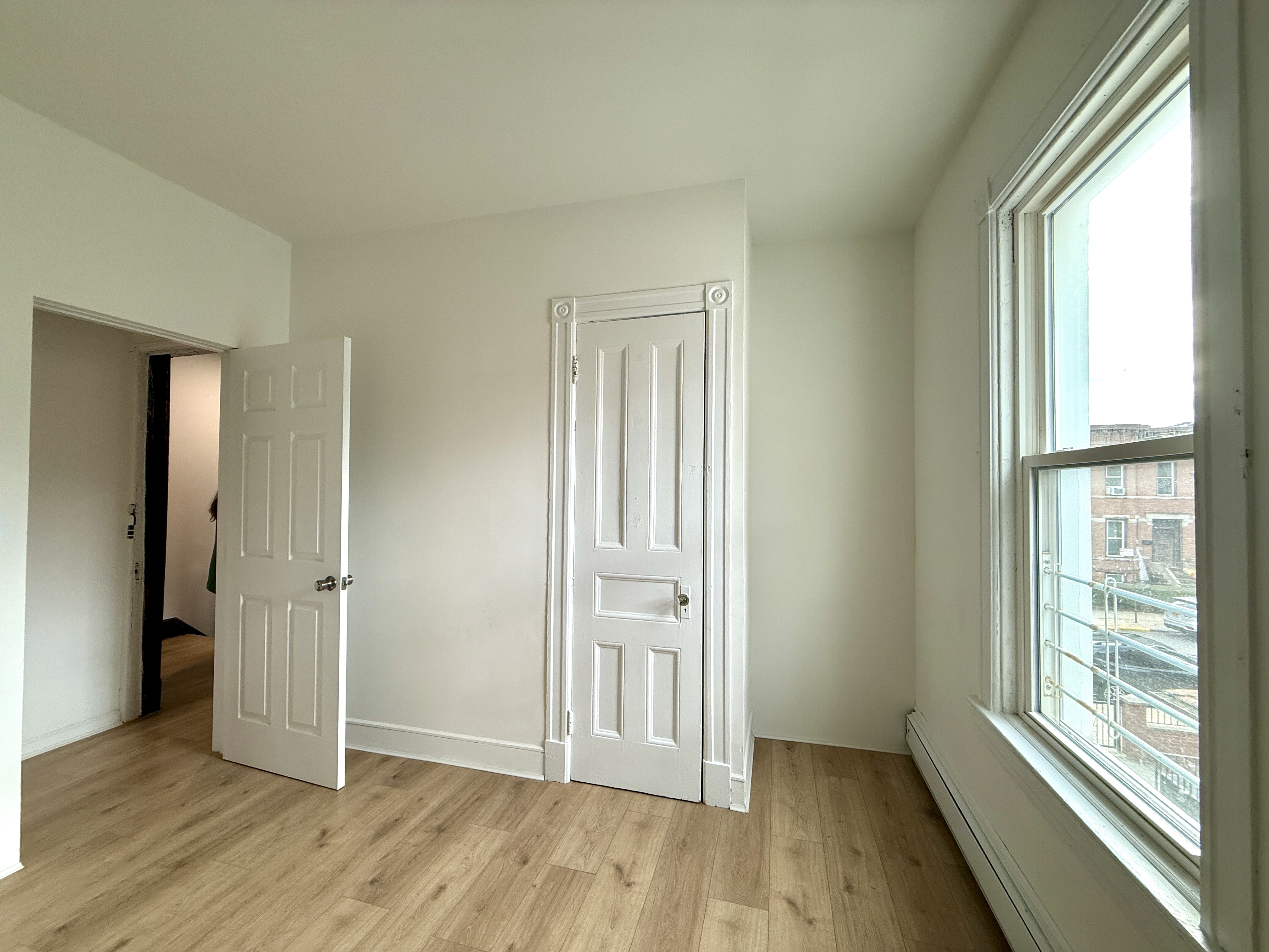 31 Seeley Street, Unit Undisclosed Brooklyn, NY 11218 - Photo 18 of 31 an empty room with wooden floor and windows