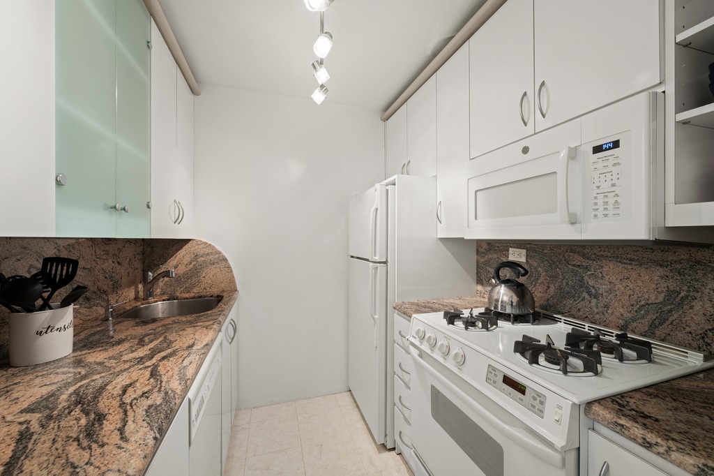 155 East 34th Street, Unit 6O Manhattan, NY 10016 - Photo 3 of 6 a kitchen with a stove and a sink