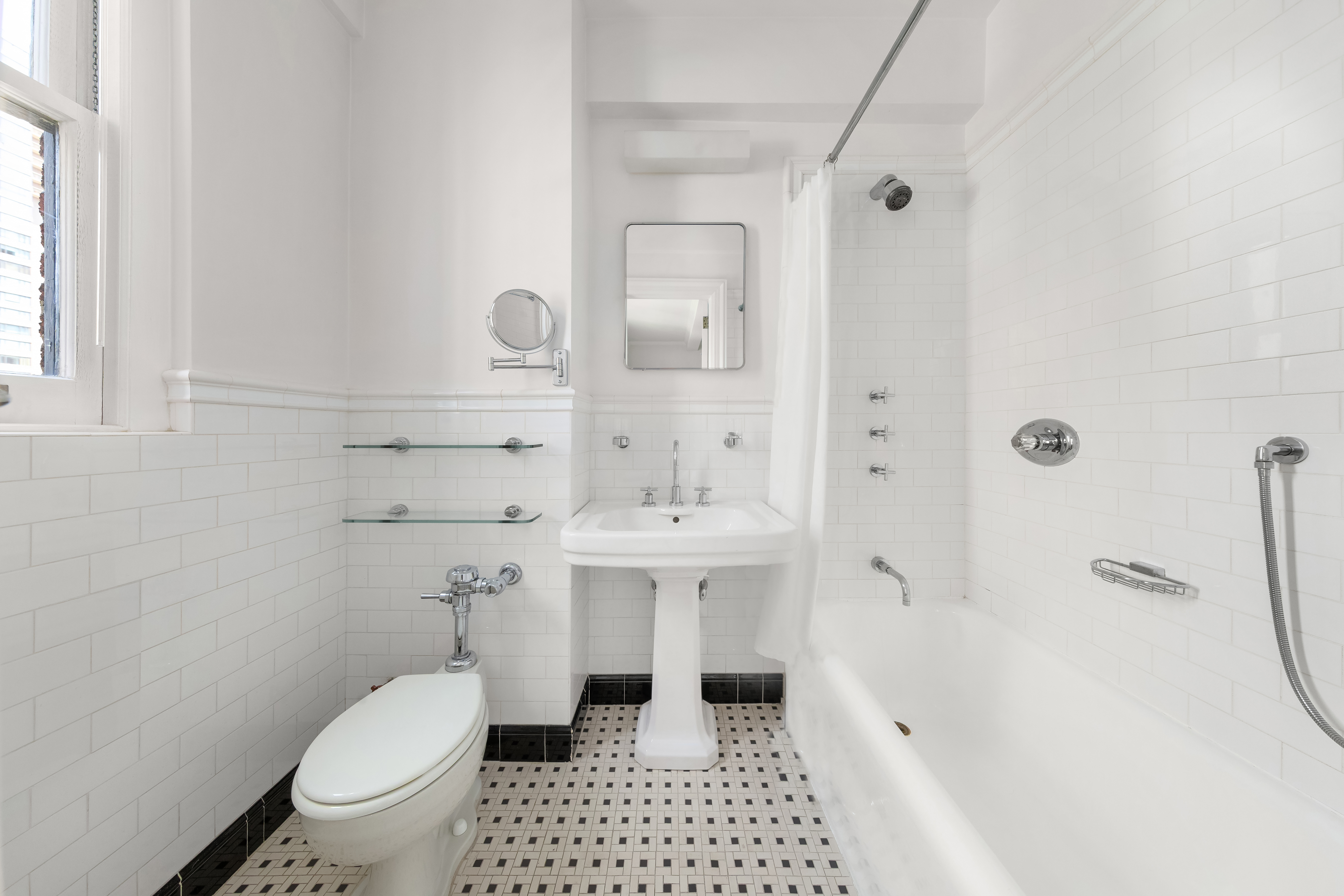 162 East 80th Street Manhattan, NY 10075 - Photo 8 of 13 a bathroom with a sink a toilet a mirror and shower