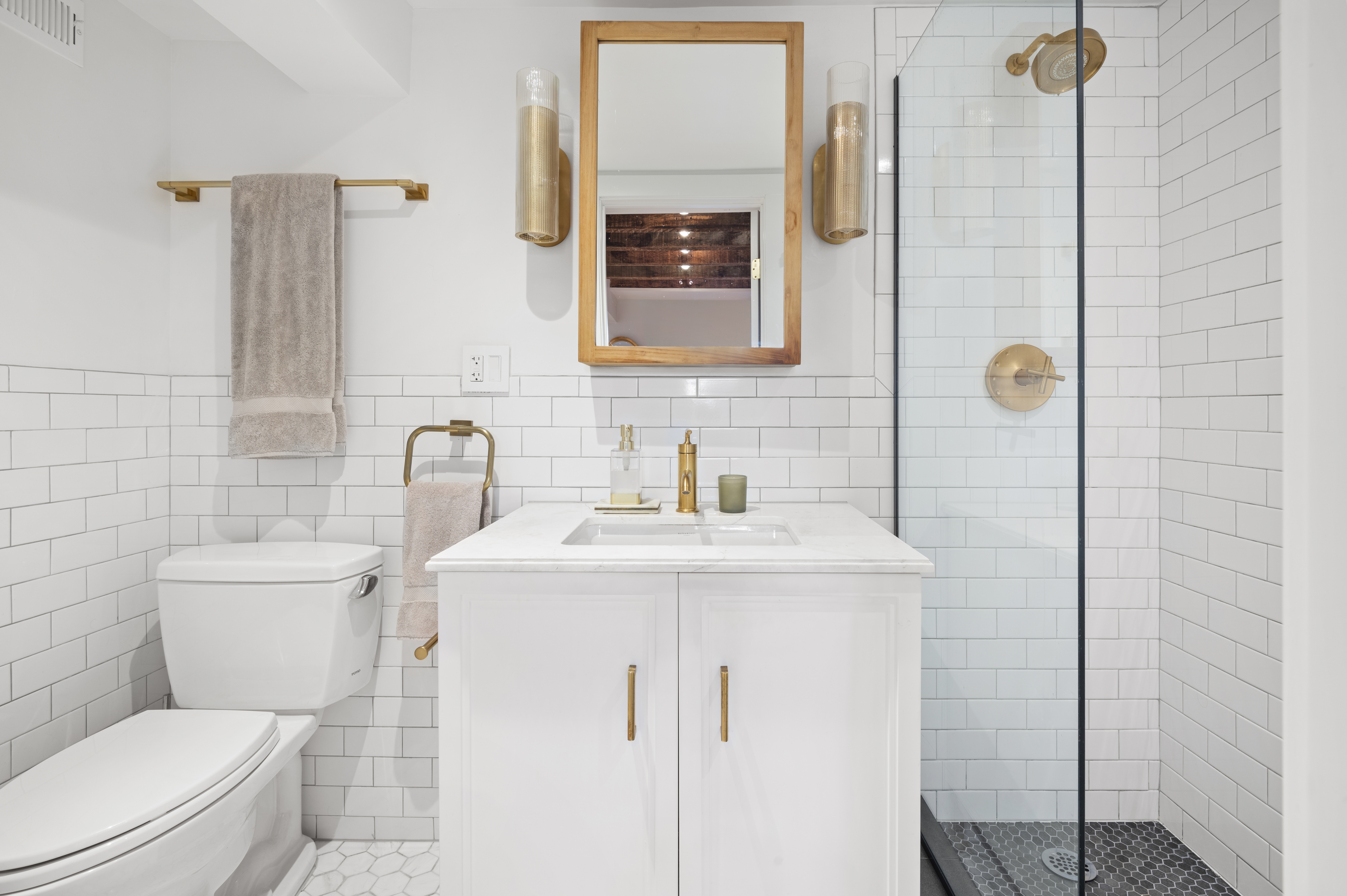 185 East 31st Street Brooklyn, NY 11226 - Photo 9 of 23 a bathroom with a toilet sink vanity and mirror