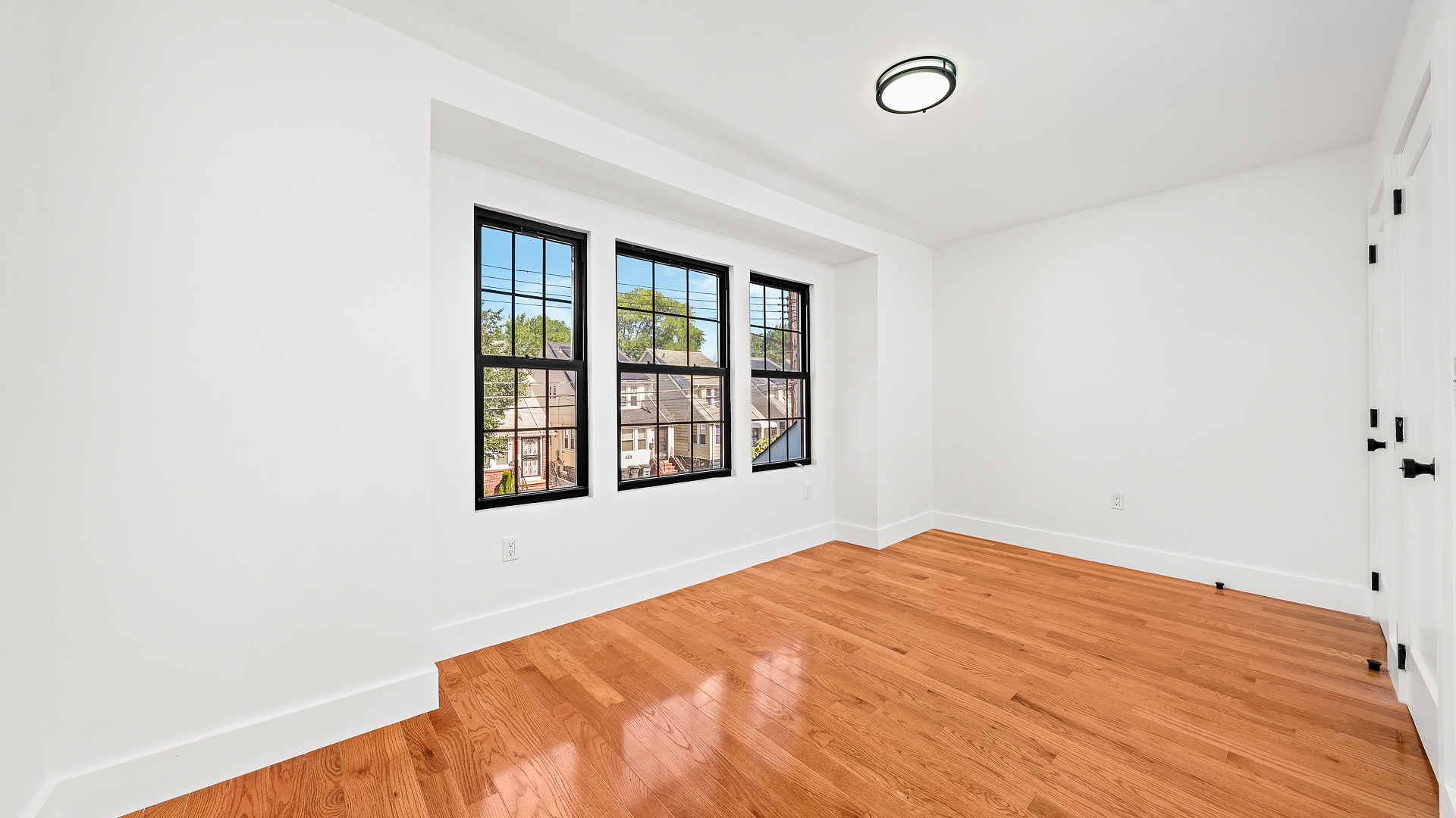 170-10 118th Avenue Queens, NY 11434 - Photo 6 of 7 a bedroom with a bed and a window