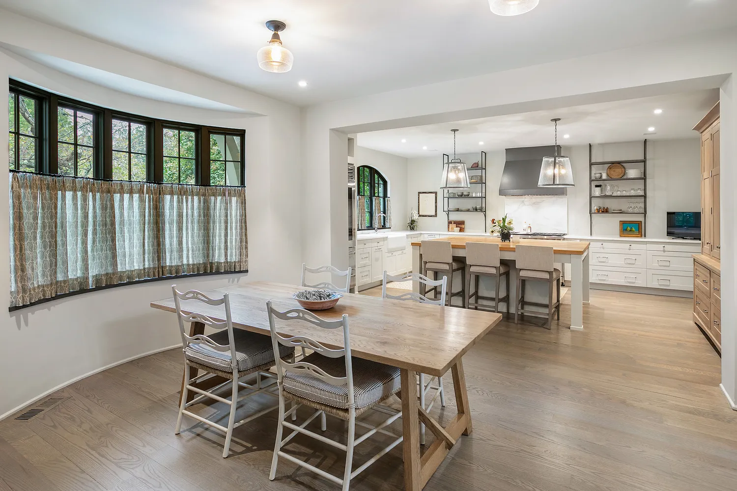 a view of a dining room with furniture and wooden floor