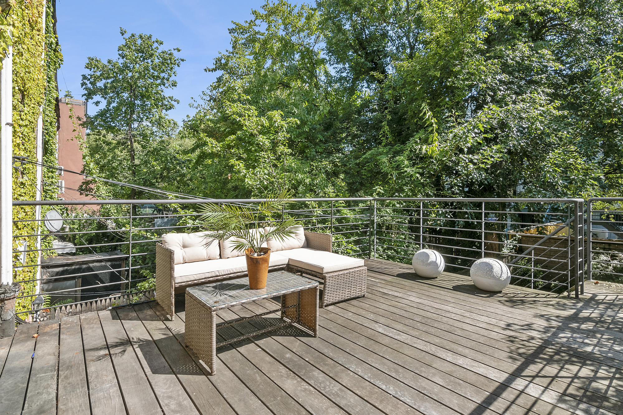 698 Halsey Street Brooklyn, NY 11233 - Photo 4 of 13 a view of a deck with couches wooden floor and fence