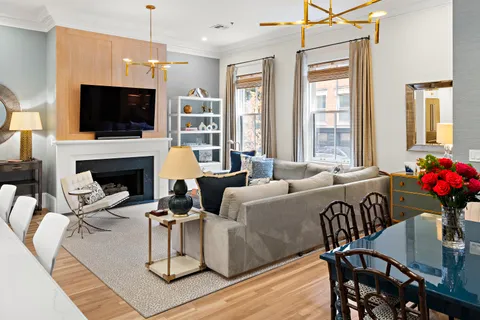 a living room with furniture fireplace and flat screen tv