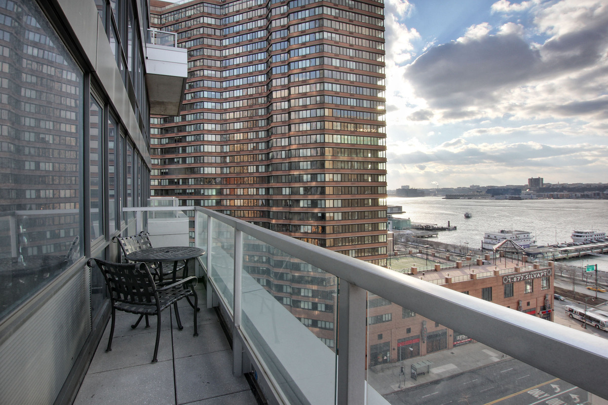 635 West 42nd Street, Unit 10A Manhattan, NY 10036 - Photo 5 of 7 a balcony with an outdoor seating