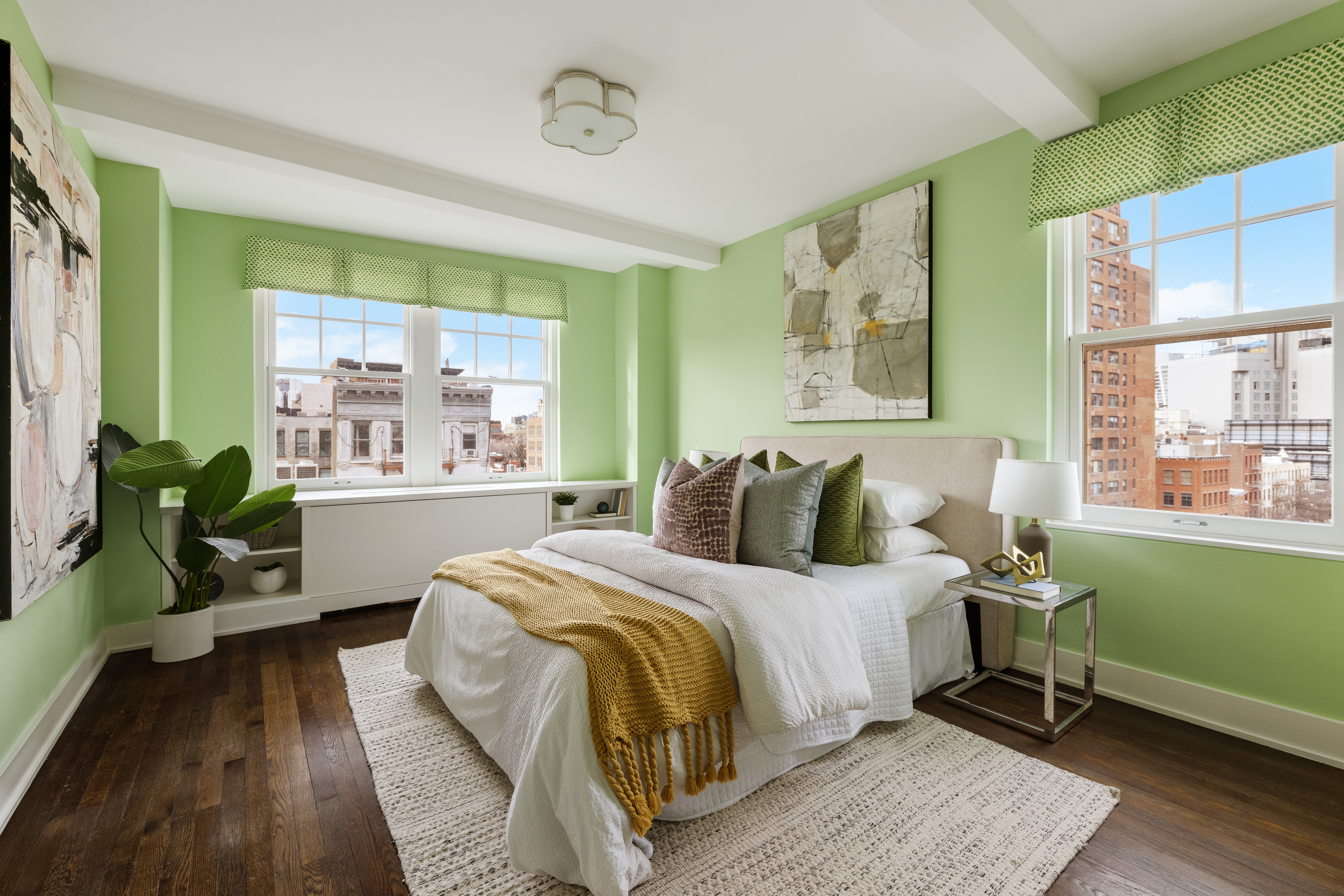 299 West 12th Street, Unit 7BC Manhattan, NY 10014 - Photo 9 of 16 a bedroom with a bed table flowerpot and window