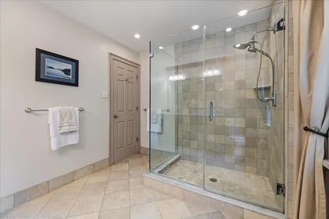 a spacious bedroom with a bed and a large window