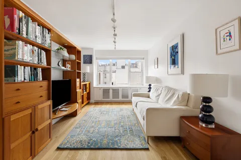 a living room with furniture fireplace and flat screen tv