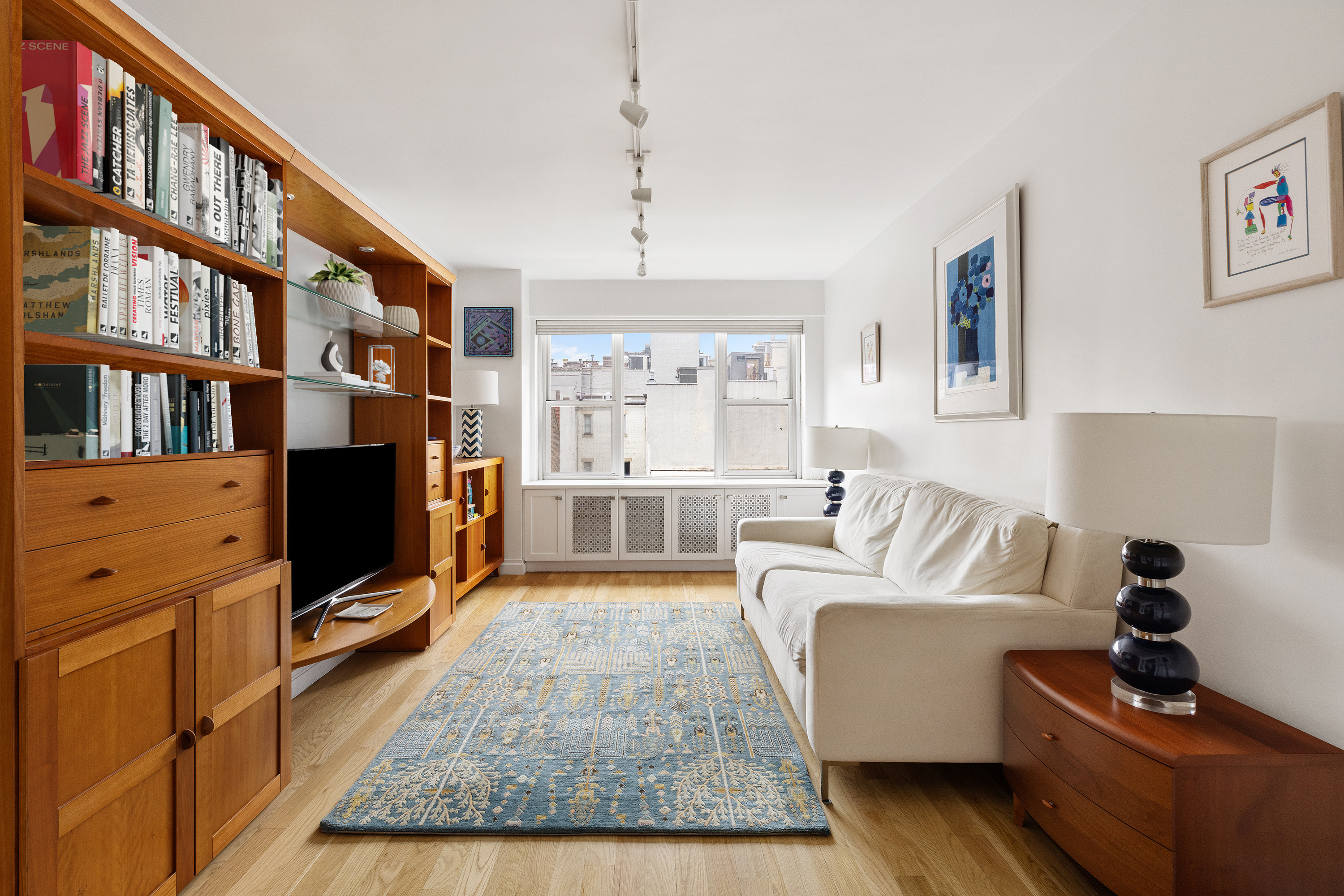 50 East 79th Street, Unit 7B Manhattan, NY 10075 - Photo 6 of 15 a living room with furniture fireplace and flat screen tv