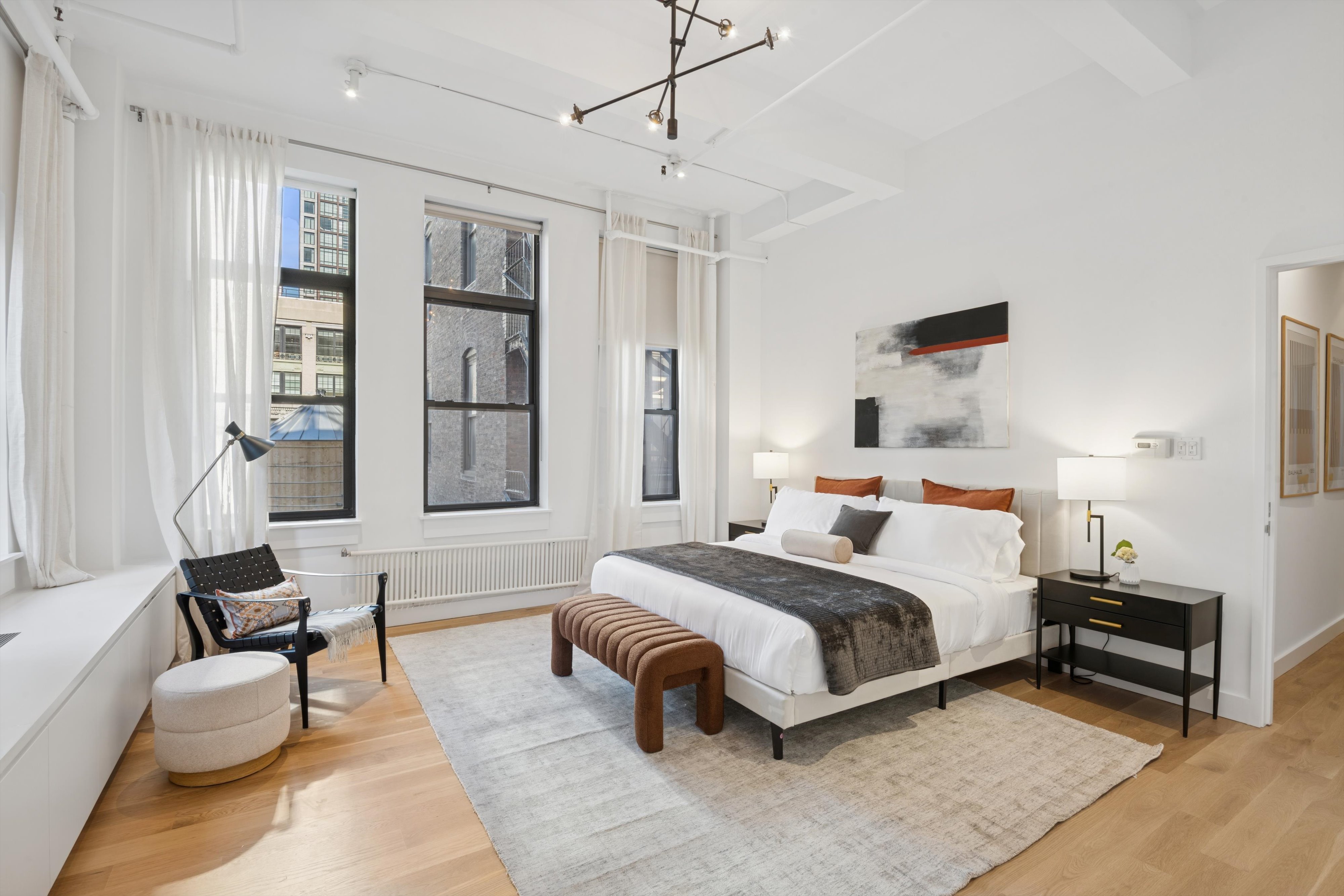 109 West 26th Street, Unit 9 Manhattan, NY 10001 - Photo 11 of 23 a bedroom with a bed wooden floor and window