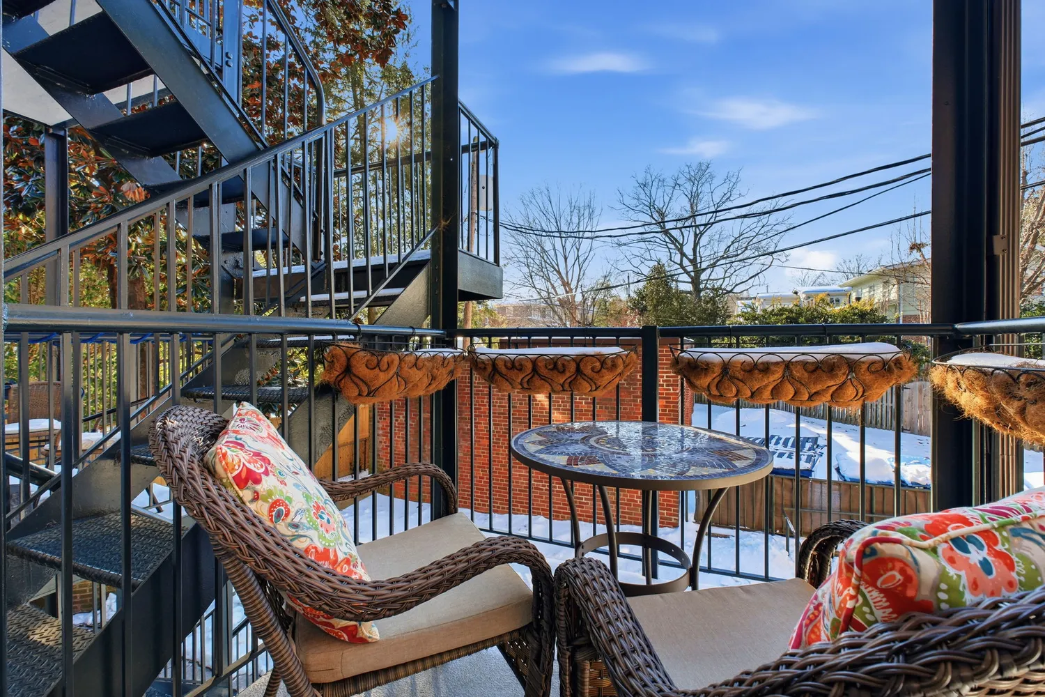 a view of a chairs and table in the balcony