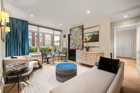 a bedroom with furniture and a large window