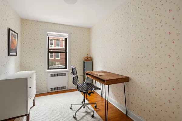 a view of a workspace with furniture and wooden floor