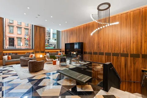 a living room with patio furniture and a flat screen tv