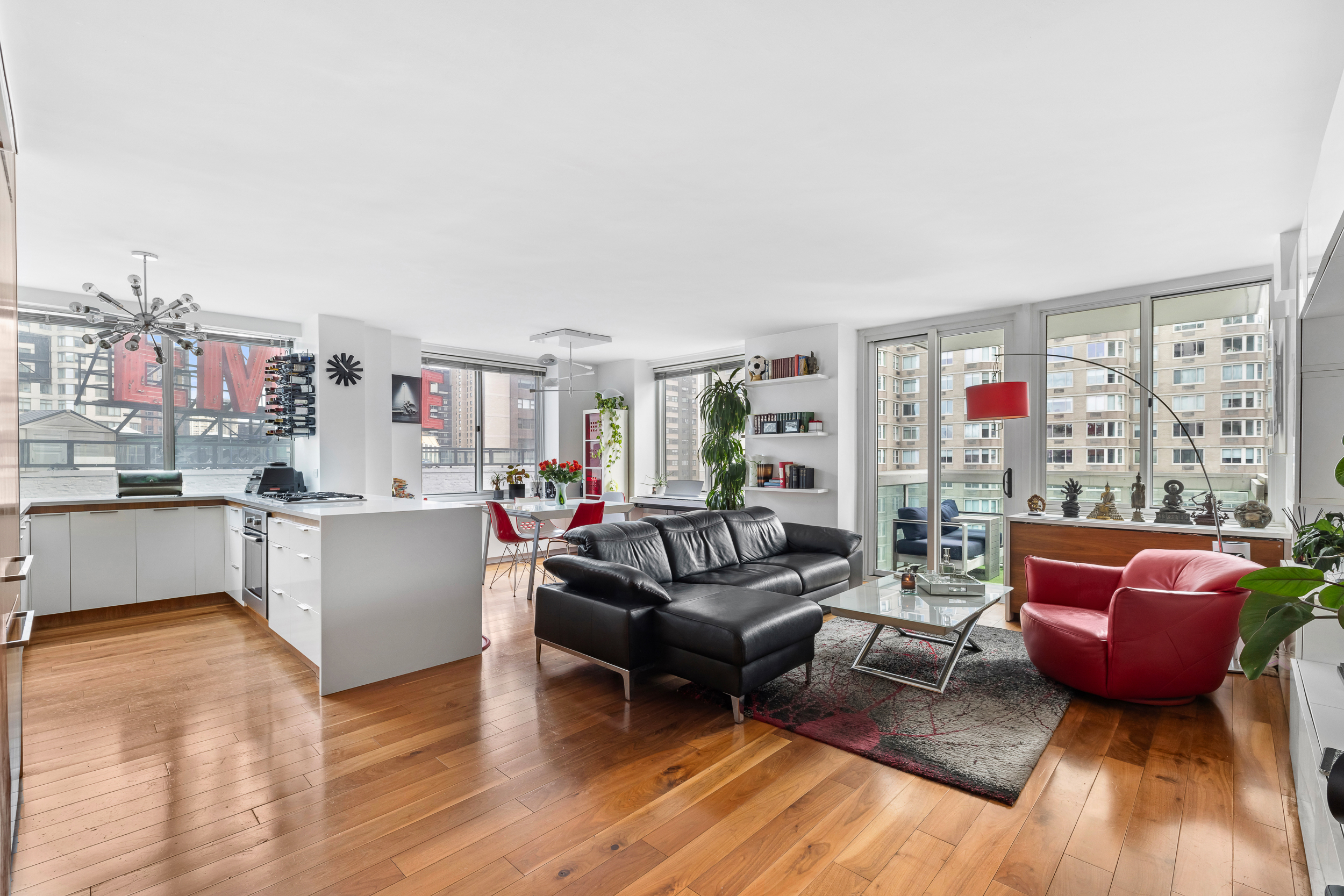 61 West 62nd Street, Unit 16D Manhattan, NY 10023 - Photo 2 of 11 a living room with furniture and a wooden floor