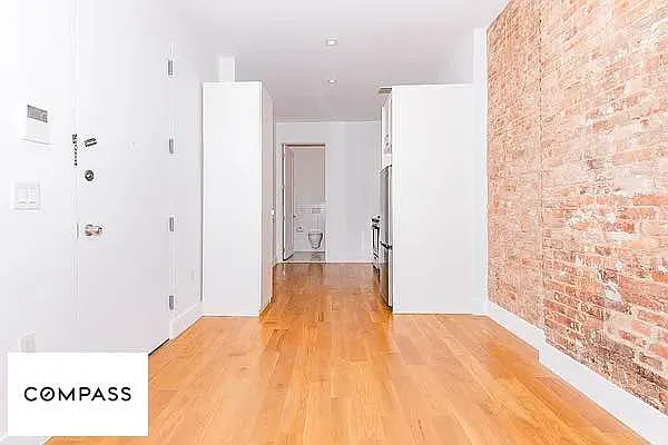 253 Stanhope Street, Unit 1B Brooklyn, NY 11237 - Photo 2 of 5 a view of a bedroom with wooden floor and bathroom
