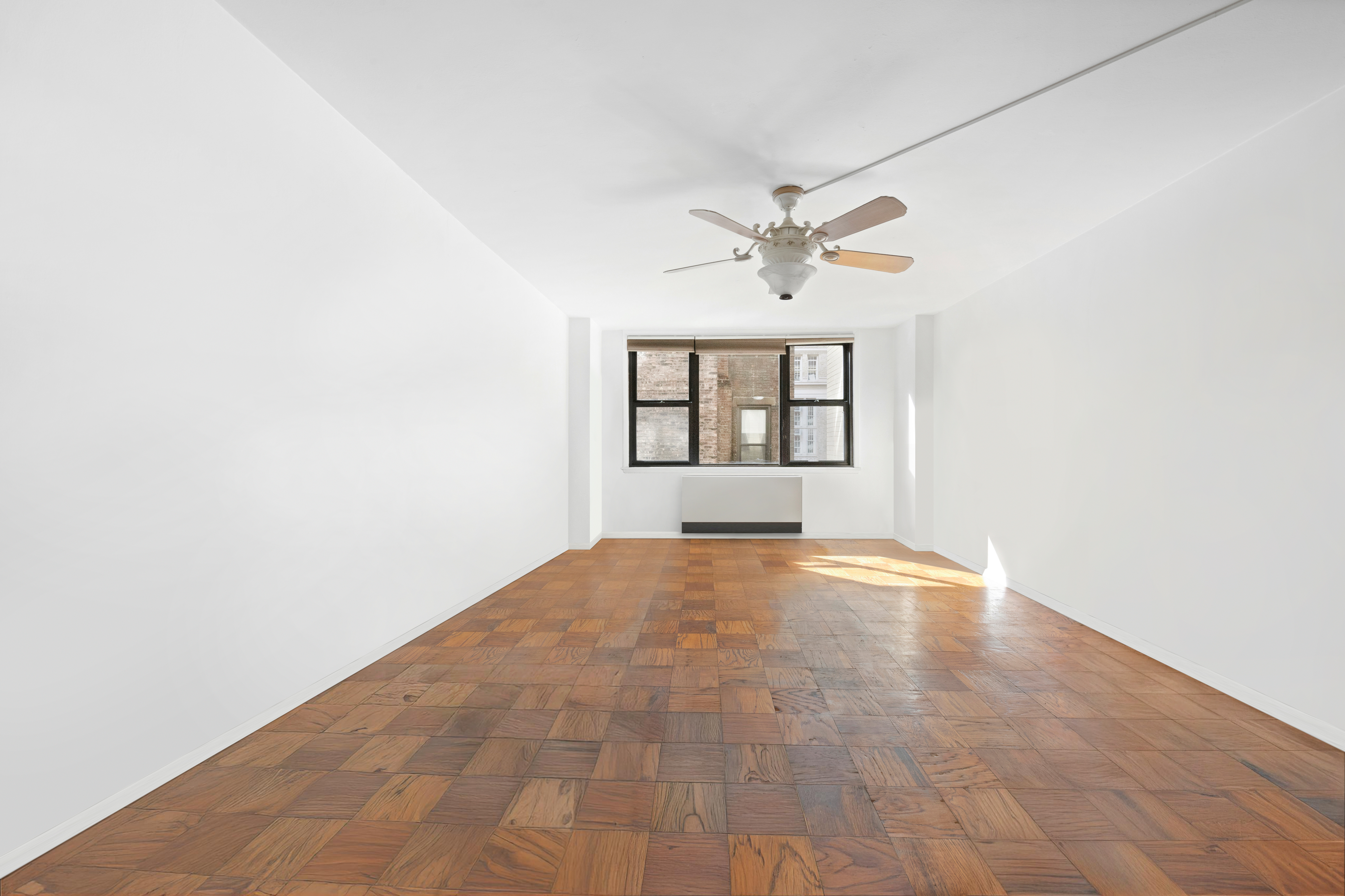 130 East 18th Street, Unit 3K Manhattan, NY 10003 - Photo 2 of 9 an empty room with windows and ceiling fan