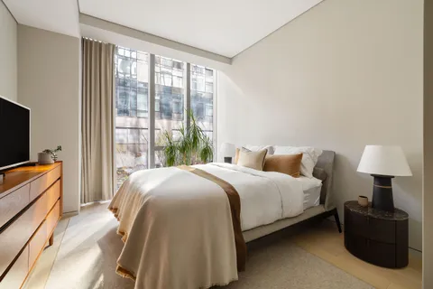 a bedroom with a bed and a television