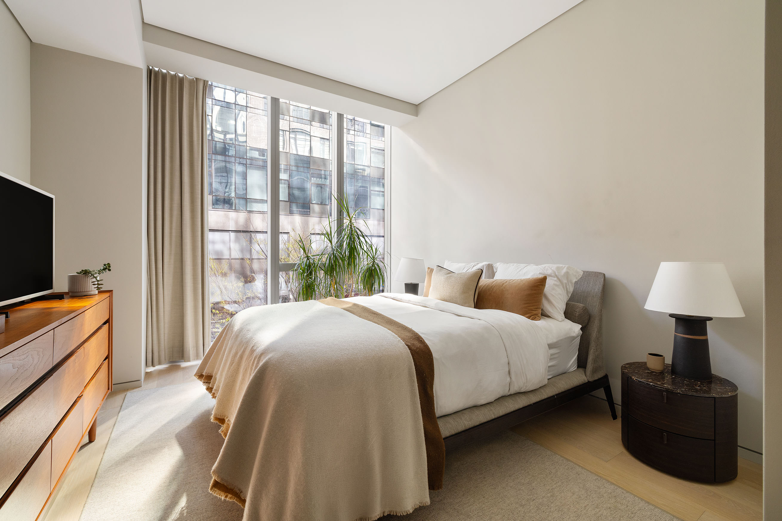 515 West 29th Street, Unit 2S Manhattan, NY 10001 - Photo 6 of 11 a bedroom with a bed and a television