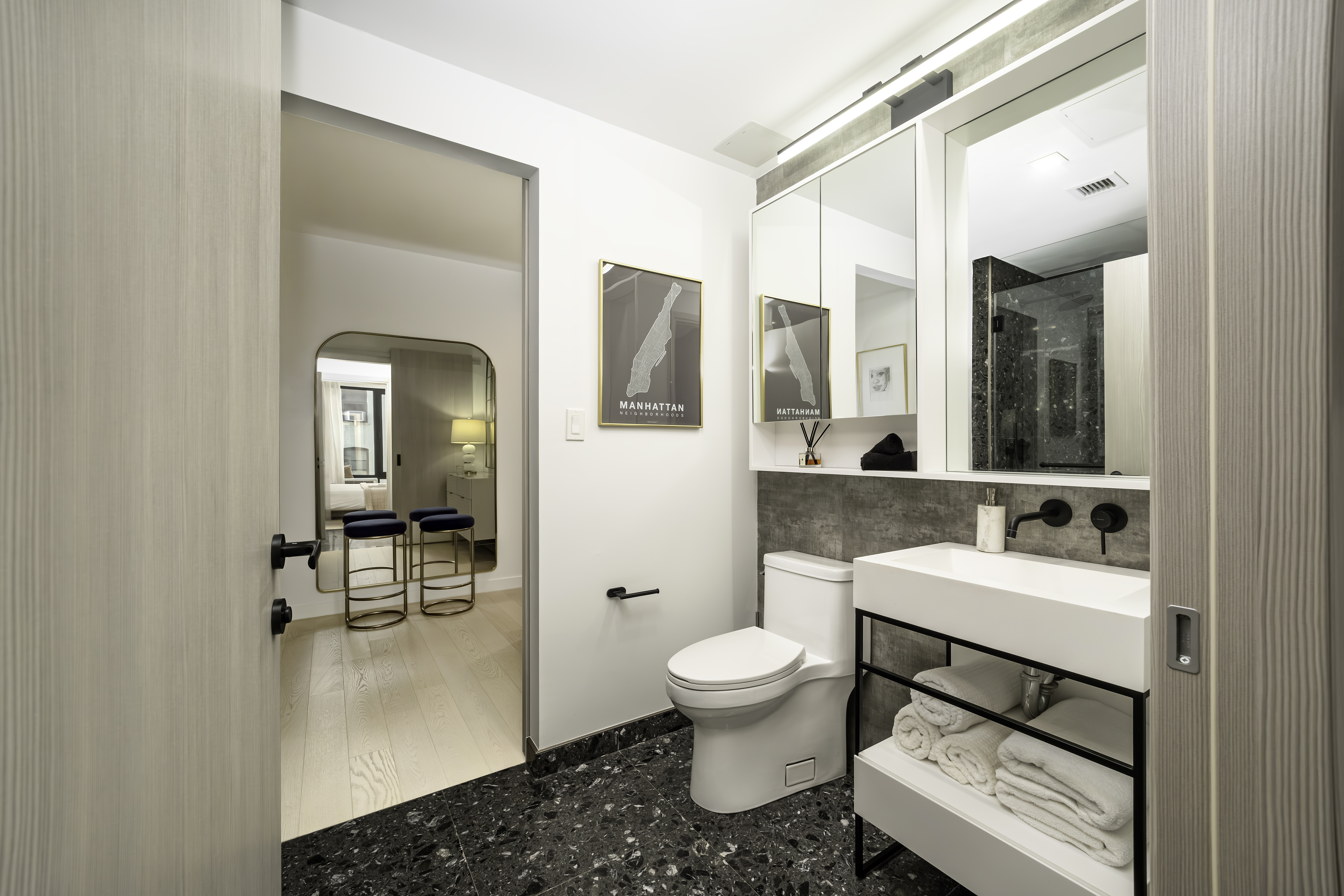 181 East 101st Street, Unit 701 Manhattan, NY 10029 - Photo 9 of 16 a bathroom with a toilet sink and mirror