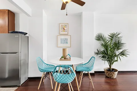 a view of a dining room with furniture and wooden floor