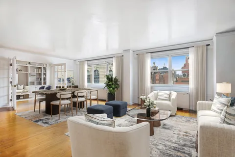a living room with furniture a large window and a table