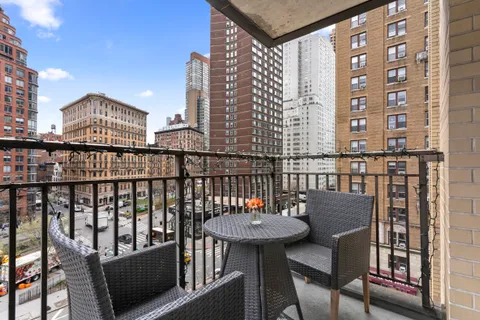 a view of a balcony with a table and chairs and wooden floor