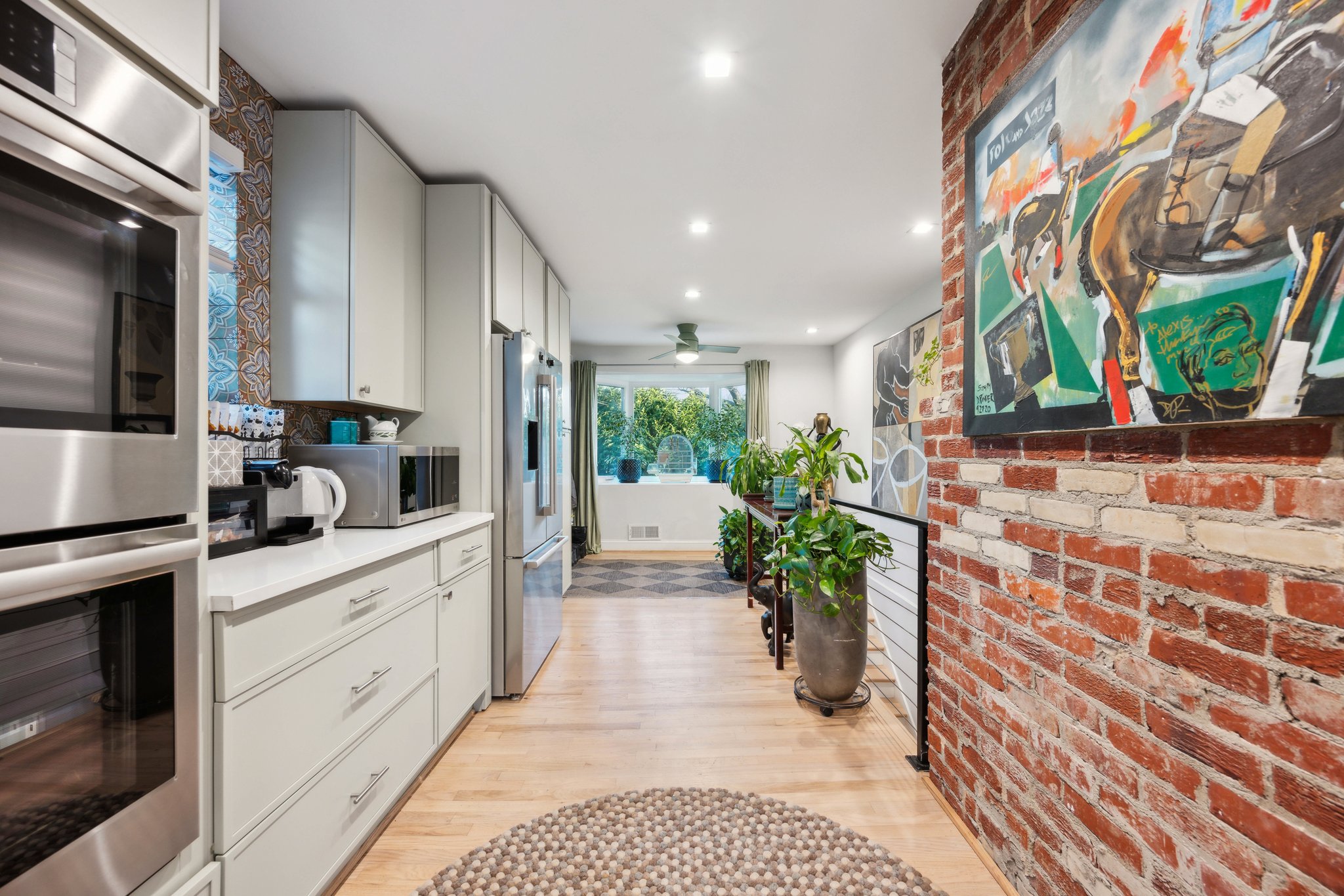 2607 Ross Road Chevy Chase, MD 20815 - Photo 9 of 37 a kitchen with stainless steel appliances kitchen island granite countertop a stove a sink and a microwave