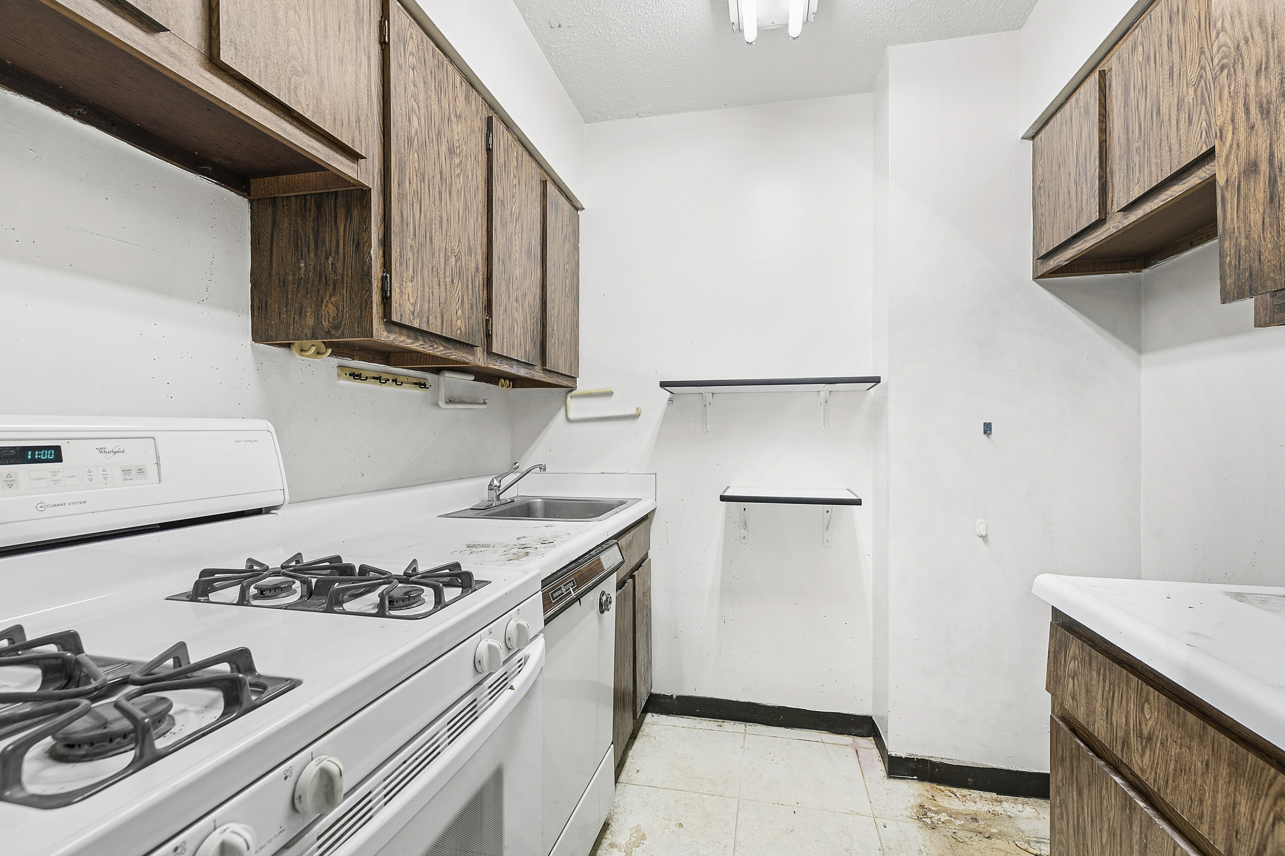 301 East 45th Street, Unit 8A Manhattan, NY 10017 - Photo 3 of 11 a kitchen with a stove and a refrigerator