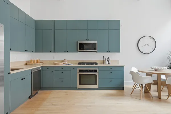 a kitchen with sink cabinets and stove top oven