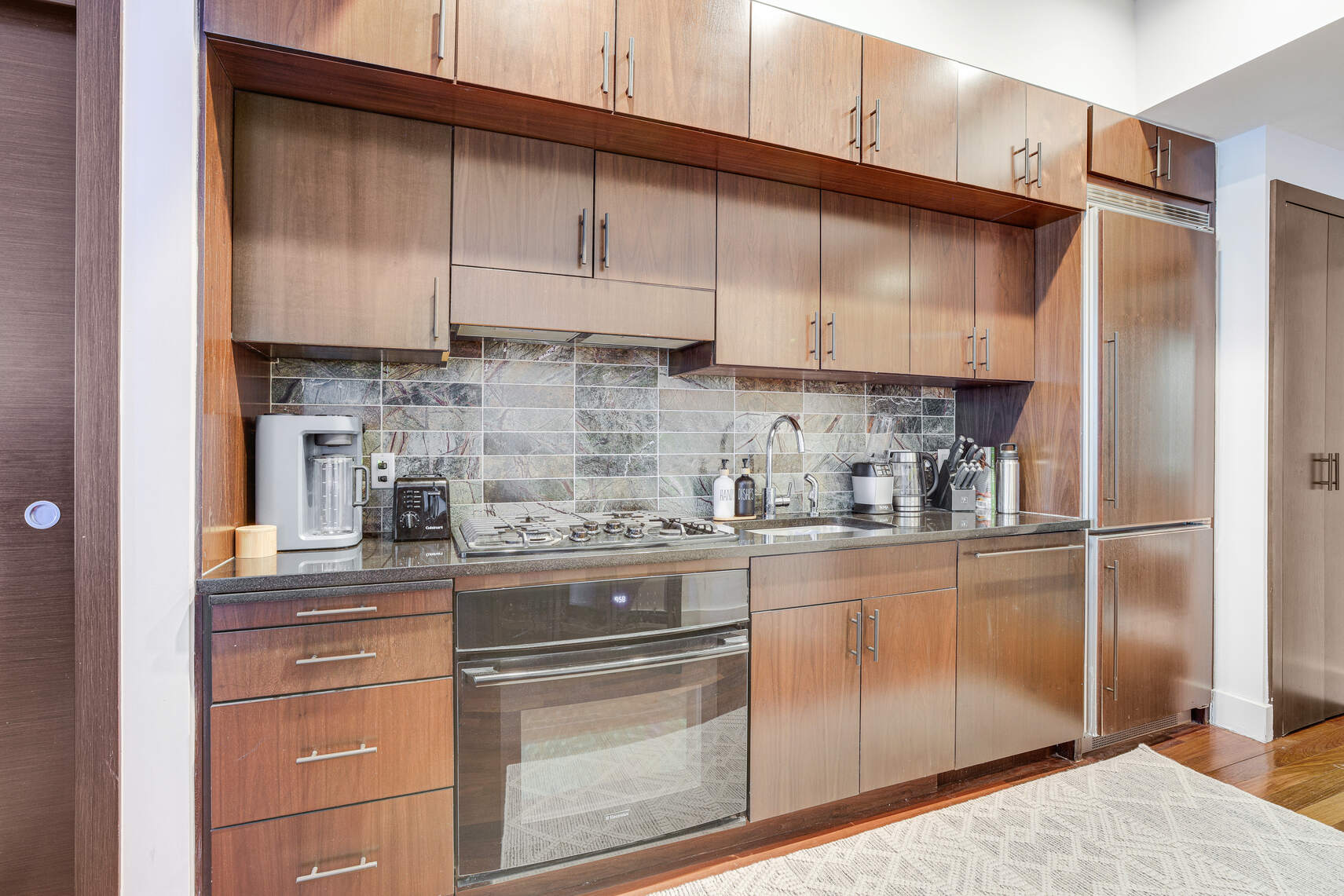 150 Myrtle Avenue, Unit 602 Brooklyn, NY 11201 - Photo 7 of 29 a kitchen with stainless steel appliances granite countertop a refrigerator sink and cabinets