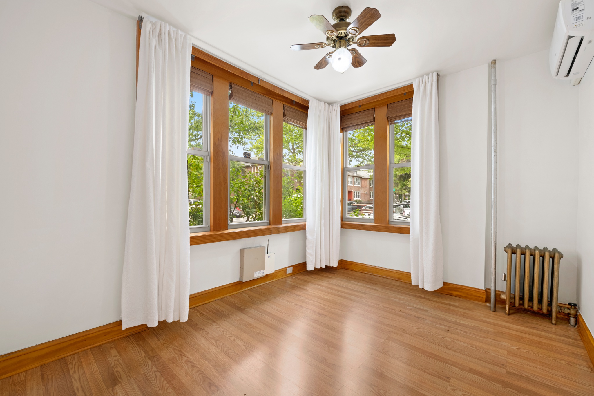 95 Chester Avenue, Unit 1 Brooklyn, NY 11218 - Photo 11 of 13 a view of an empty room with a window and wooden floor