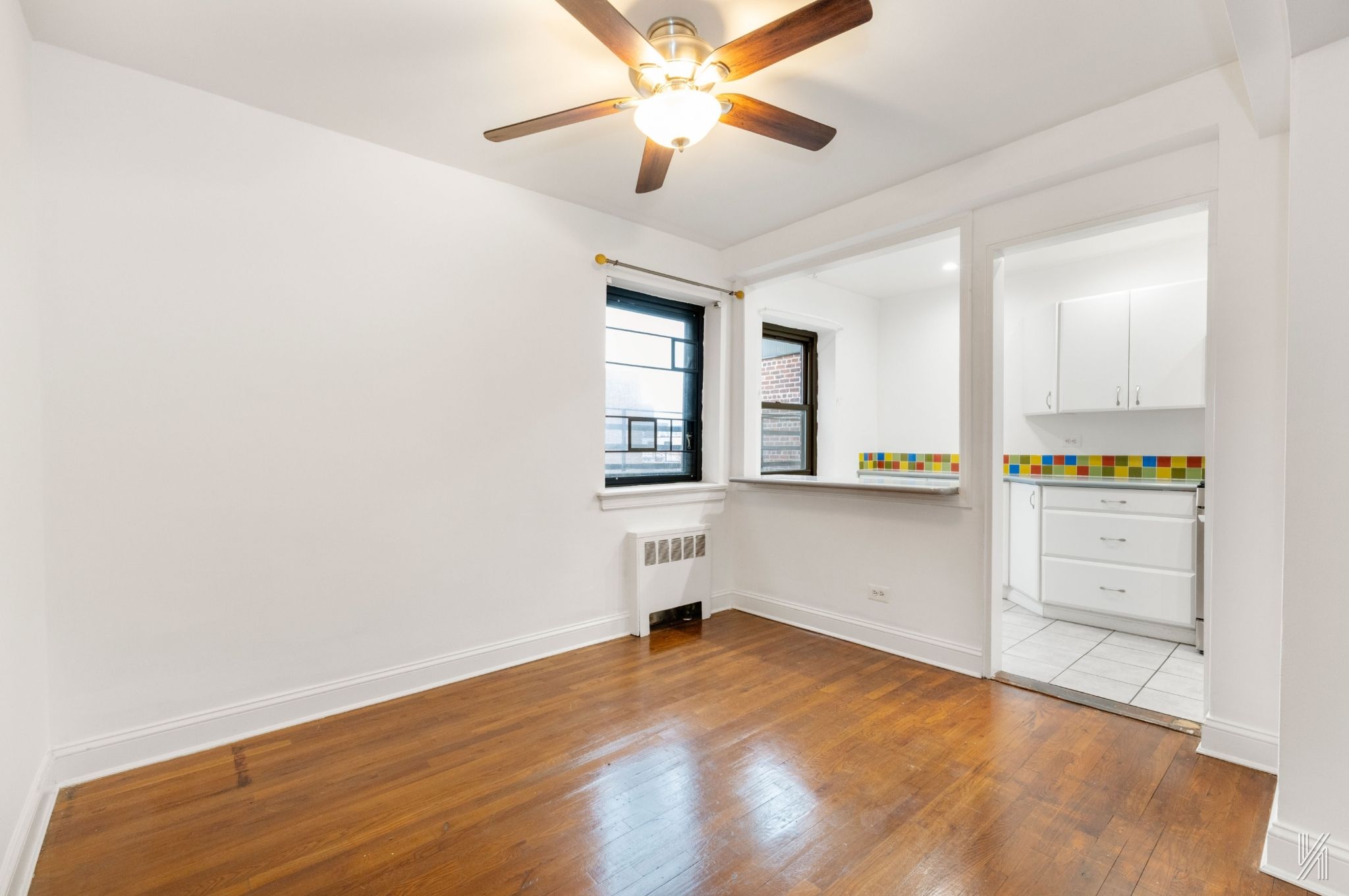 34-10 94th Street, Unit 6G Queens, NY 11372 - Photo 6 of 19 a view of empty room with wooden floor and fan