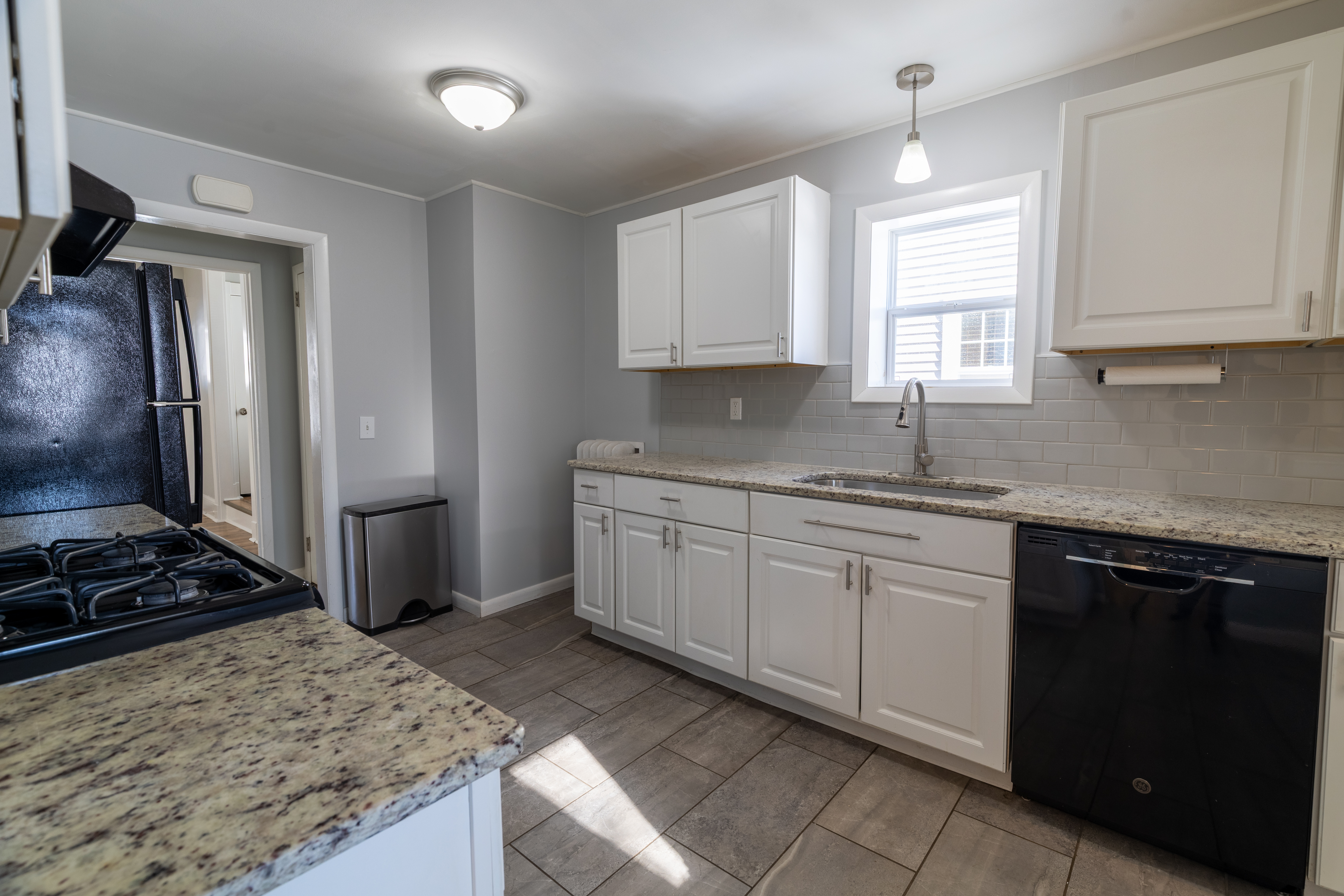 90 School Street New London, CT 06320 - Photo 12 of 34 a kitchen with kitchen island granite countertop a sink stove and refrigerator