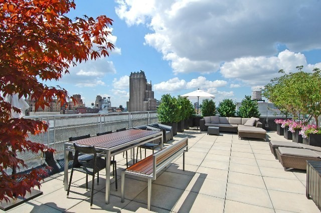 121 West 19th Street, Unit 10C Manhattan, NY 10011 - Photo 12 of 14 a view of a patio with a table and chairs and potted plants