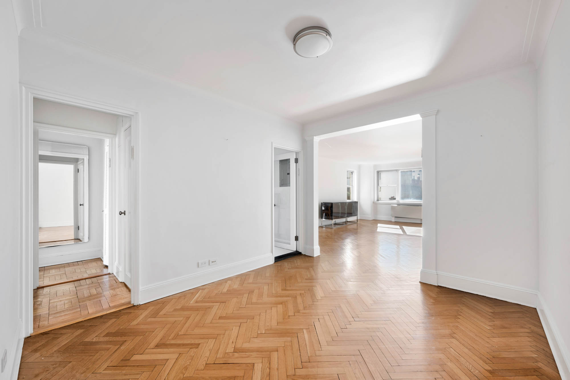923 5th Avenue, Unit 8F Manhattan, NY 10021 - Photo 3 of 8 a view of a room with wooden floor and a bathroom