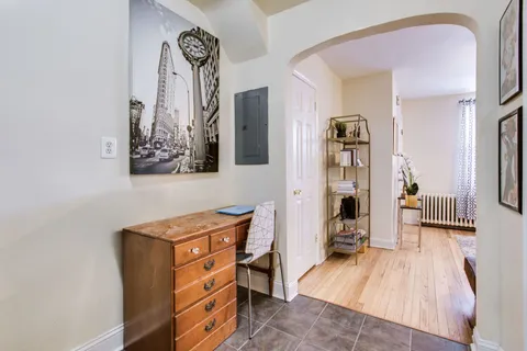 a view of a bedroom with furniture and wooden floor