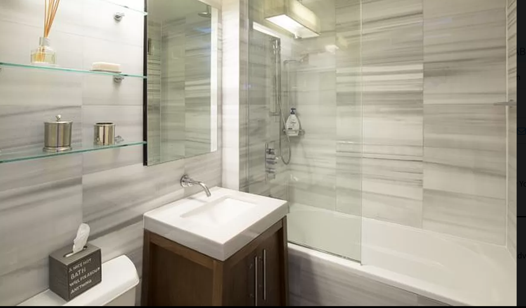 88 Greenwich Street, Unit 911 Manhattan, NY 10006 - Photo 4 of 10 a bathroom with a sink and a mirror