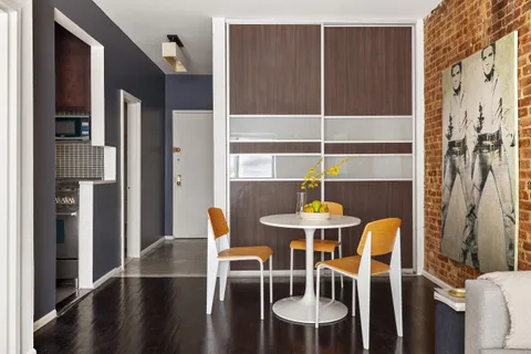 a dining room with furniture and wooden floor