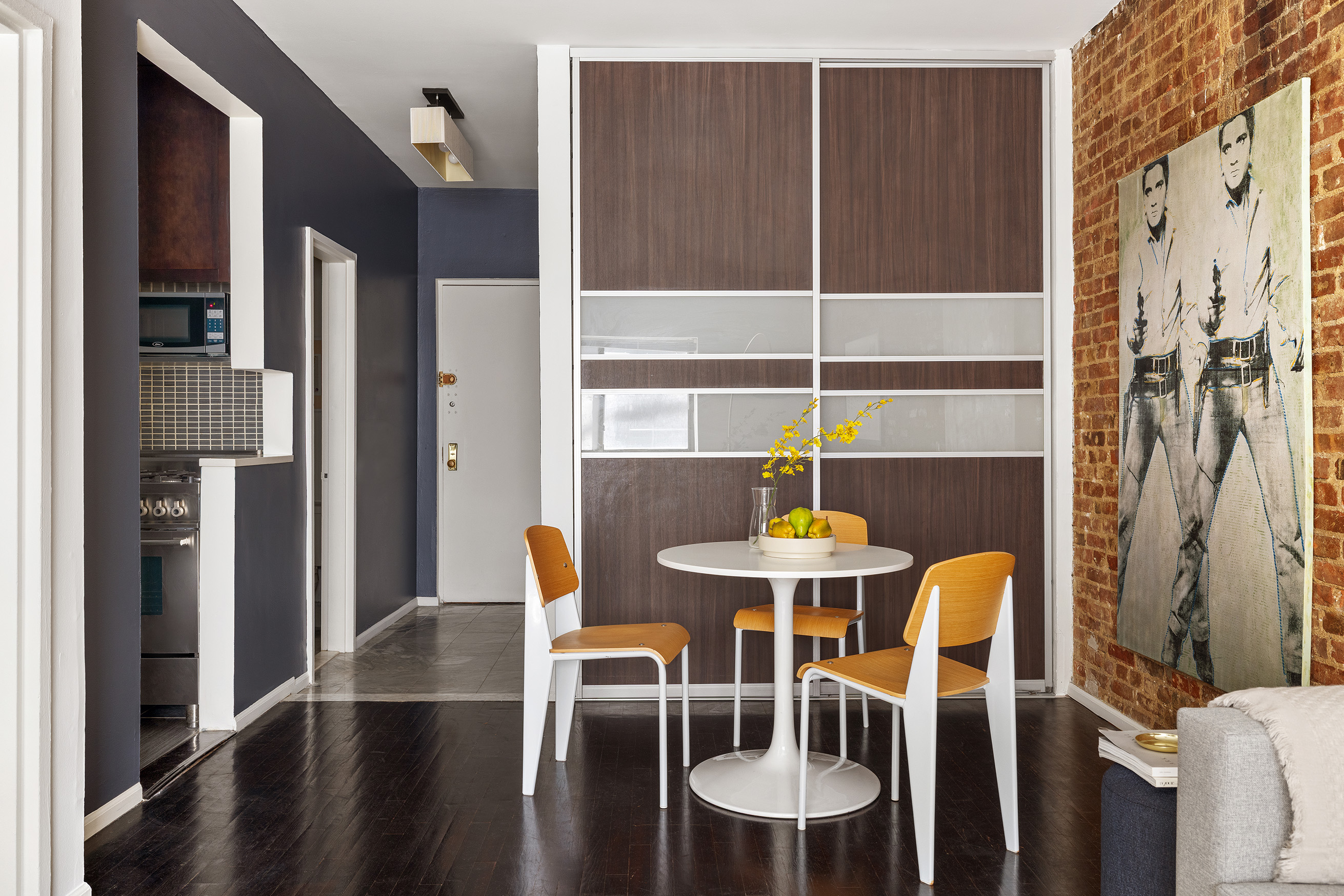 207 East 21st Street, Unit 2A Manhattan, NY 10010 - Photo 3 of 7 a dining room with furniture and wooden floor